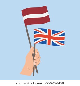 Flags of Latvia and UK, Hand Holding flags