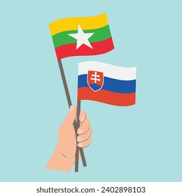 Banderas de Myanmar y Eslovaquia, mano con banderas