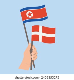Banderas de Corea del Norte y Dinamarca, con banderas de mano