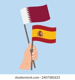 Banderas de Qatar y España, con banderas de mano