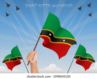 The flags of Saint Kitts and Nevis flutter under the blue sky