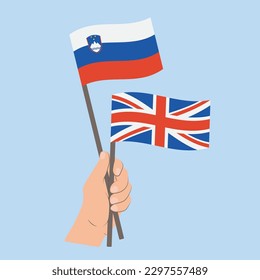 Flags of Slovenia and UK, Hand Holding flags