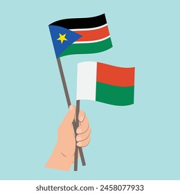 Flags of South Sudan and Madagascar, Hand Holding flags