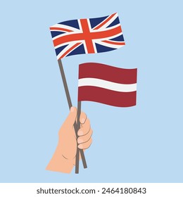 Flags the United Kingdom of Great Britain and Northern Ireland and Latvia, Hand Holding flags