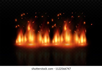 Flame of fire with sparks on a black background. The texture of the fiery storm. The fiery sparks of Boke's lights flash, a shot of a flying spark in the air.over a dark night.