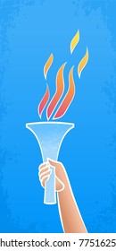 Flaming Torch. Human hand holding torch with a flame on blue sky background.