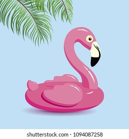 Flamingo inflatable and tropical leaves on blue background minimal summer