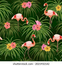 Flamingos and flowers in a pattern.Flamingos on a background of tropical flowers and leaves in a color vector pattern.