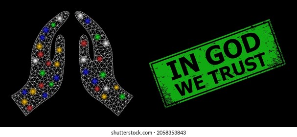 Flare mesh web pray hands with colorful glowing spots, and grunge In God We Trust seal stamp. Green stamp seal has In God We Trust tag inside framed rectangle.