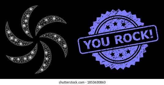 Rotación de turbinas de red de destello con puntos de luz, y ¡Roca usted! sello de cinta arañada. ¡El sello azul tiene a You Rock! leyenda dentro de rosette.