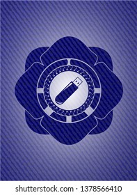 flash drive icon inside badge with denim background