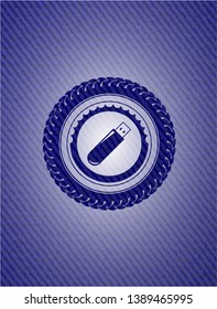 flash drive icon inside badge with denim texture