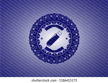 flash drive icon inside emblem with jean background