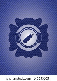 flash drive icon inside emblem with denim texture