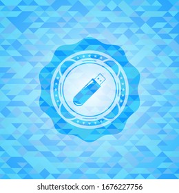 flash drive icon inside light blue emblem with triangle mosaic background