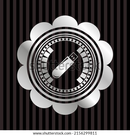 flash drive icon inside silver emblem or badge. 