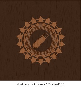 flash drive icon inside vintage wood emblem
