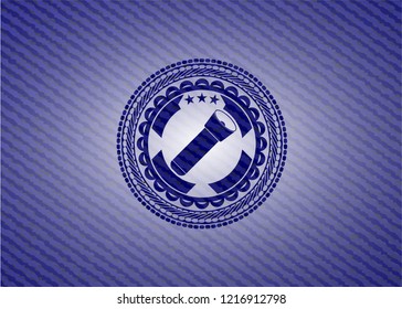 flashlight icon inside badge with denim background