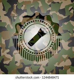 flashlight icon inside camouflaged emblem