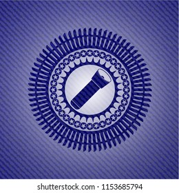 flashlight icon inside emblem with denim texture