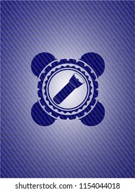 flashlight icon inside emblem with denim high quality background