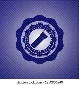 flashlight icon inside emblem with denim texture