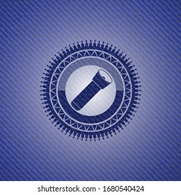 flashlight icon inside emblem with denim texture