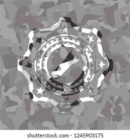 flashlight icon inside grey camouflage emblem