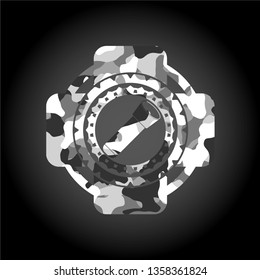 flashlight icon inside grey camouflage emblem