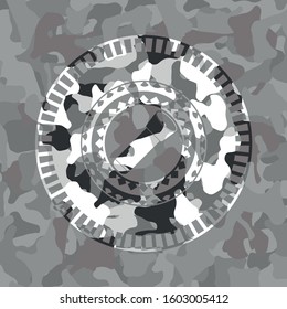 flashlight icon inside grey camouflage emblem