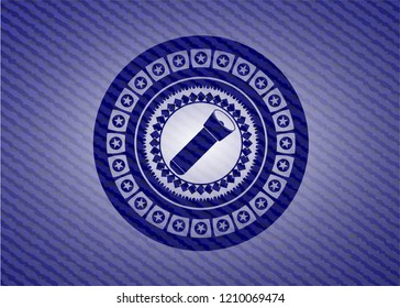 flashlight icon inside jean or denim emblem or badge background