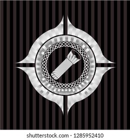 flashlight icon inside silvery emblem