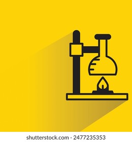 flask on burner with shadow on yellow background