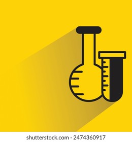 flask and test tube with shadow on yellow background