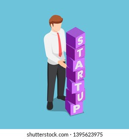 Flat 3d isometric businessman arranging blocks with the word STARTUP. Business startup concept.