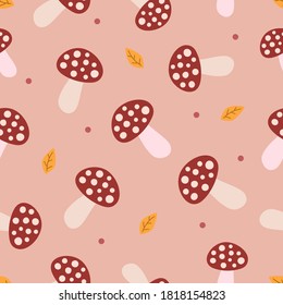 Flat brown mushrooms, calm dots and orange leaves on light pink background. Seamless autumn doodle pattern. Suitable for wrapping, textile.