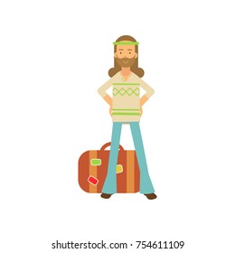 Flat cartoon bearded man hippie standing with arms akimbo near retro suitcase. Happy male with long hair, in classic sixties hippy subculture clothes. Flower child. Love and pacifism. Vector on white