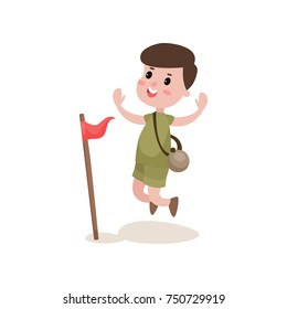 Flat cartoon boy scout character jumping with hands up near red flag