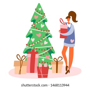 Flat cartoon girl or woman standing near decorated Christmas tree and holding gift box with bow preparing for winter holidays. Vector illustration.