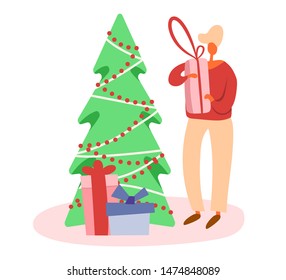 Flat cartoon man with gift box near decorated Christmas tree preparing presents for winter holidays. Isolated vector illustration.