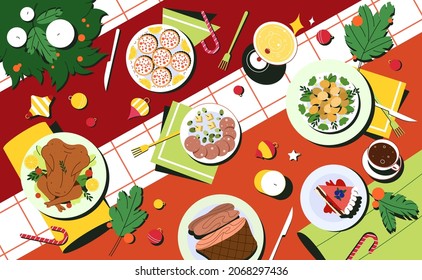 Flat christmas table top view with traditional dishes. Meals in plates, drink and decorated cutlery. Red tablecloth with holiday food, candles and spruce wreath of fir branches.