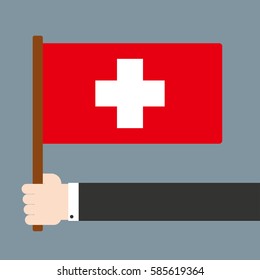 Flat design. Hand holding flag Switzerland