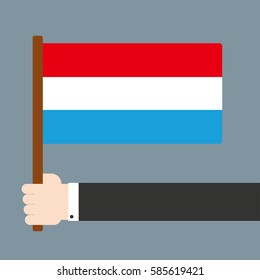 Flat design. Hand holding flag Luxembourg