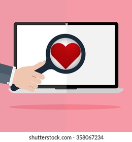 Flat design human hand holding a magnifying glass for finding love and heart icon on laptop monitor on pink background. Concept for online internet dating.