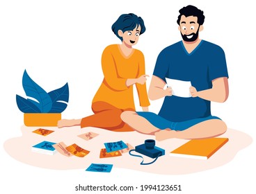 Flat design illustration with couple looking at old printed family photos.