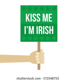 Flat design kiss me i'm irish sign in man's hand. Symbol of St.Patrick's Day.
