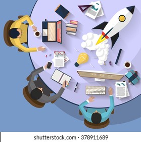 Flat design. top view of team of coworkers working together around a desk.working with laptop and tablet and smarth-phone to launch a new business project and new innovation product on a market.