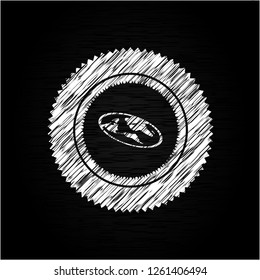 flat earth icon inside chalkboard emblem on black board