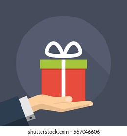 Flat Gift Box Illustration on a Hand Palm. Long Shadow Icon
