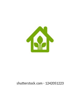 Flat green home with green leaf inside. Simple silhouette of the house with green roof and chimney. Icon isolated on white. Vector building symbol. Eco friendly house. recycle and reuse home sign.
